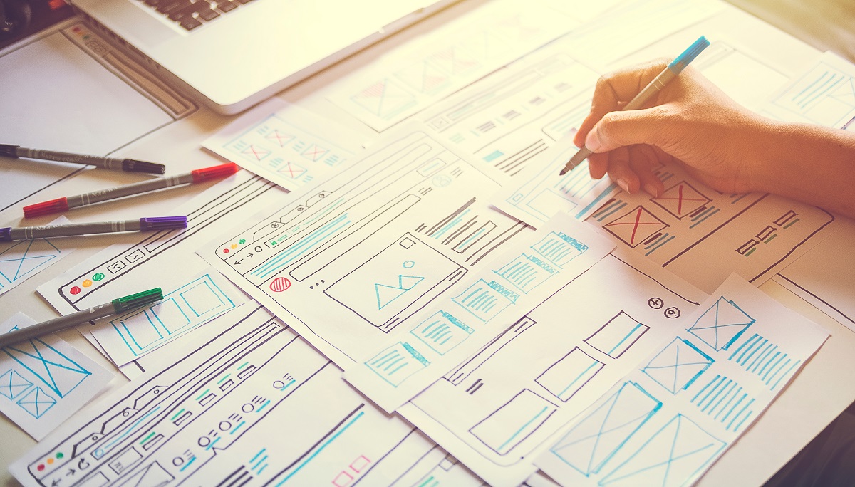 Graphic designer sketching website design