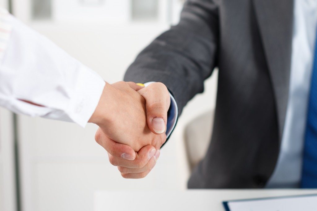 Businesspeople shaking hands after a negotiation