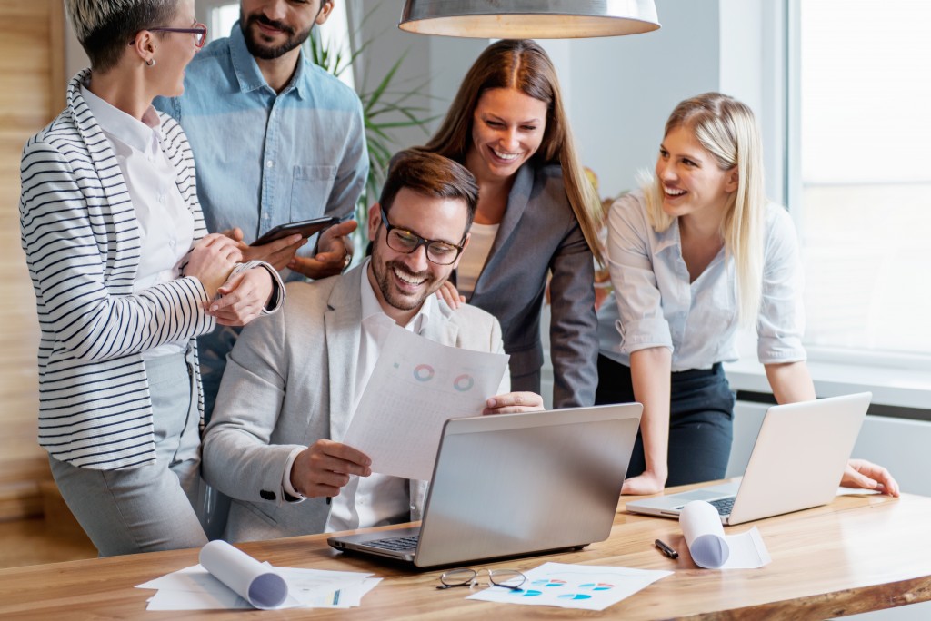 employees looking at laptop screen