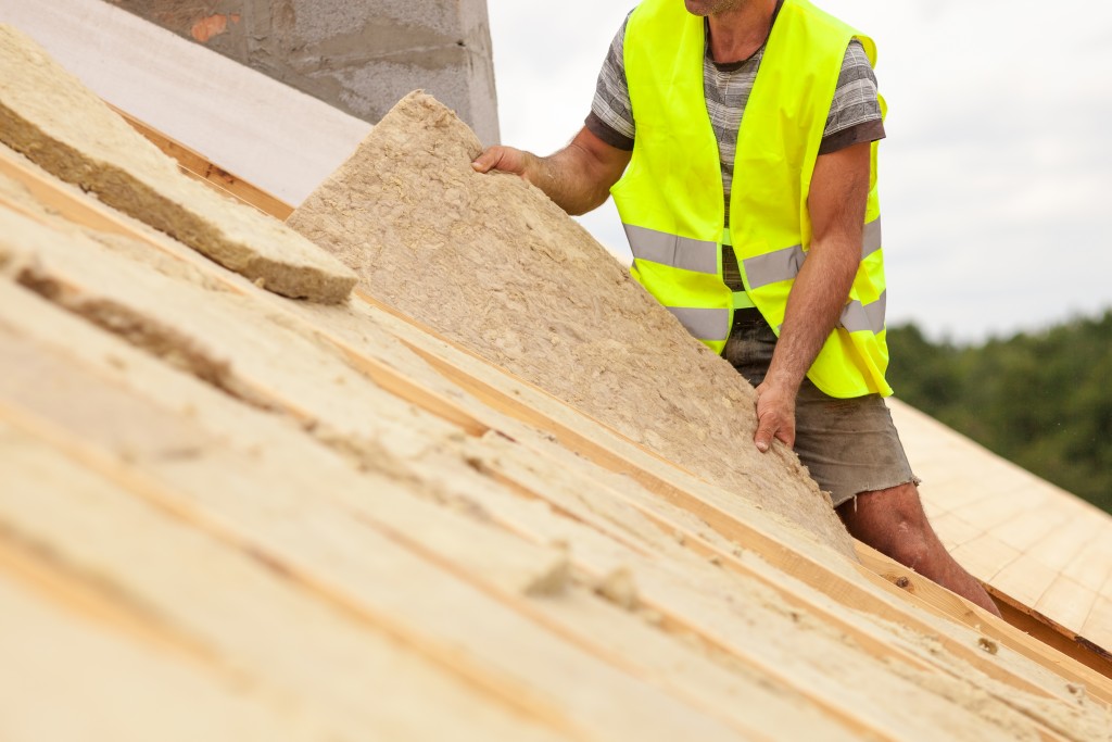 construction worker installing soundproofing